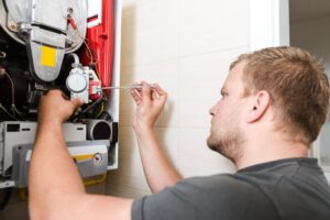 A Man Repairing a Water Heater in South Kansas City