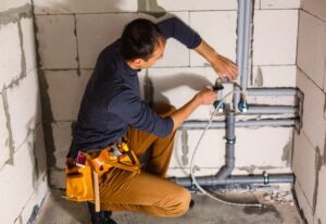 Plumber fixing pipe busting in South Kansas City