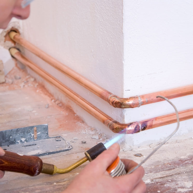 plumber installing copper pipe