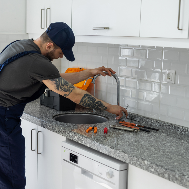 repair man fixing a sink