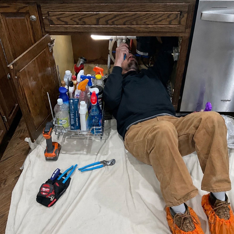 plumber repairing sink