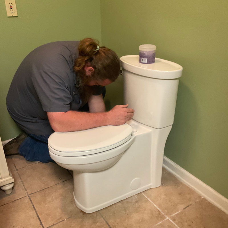 plumber replacing a toilet