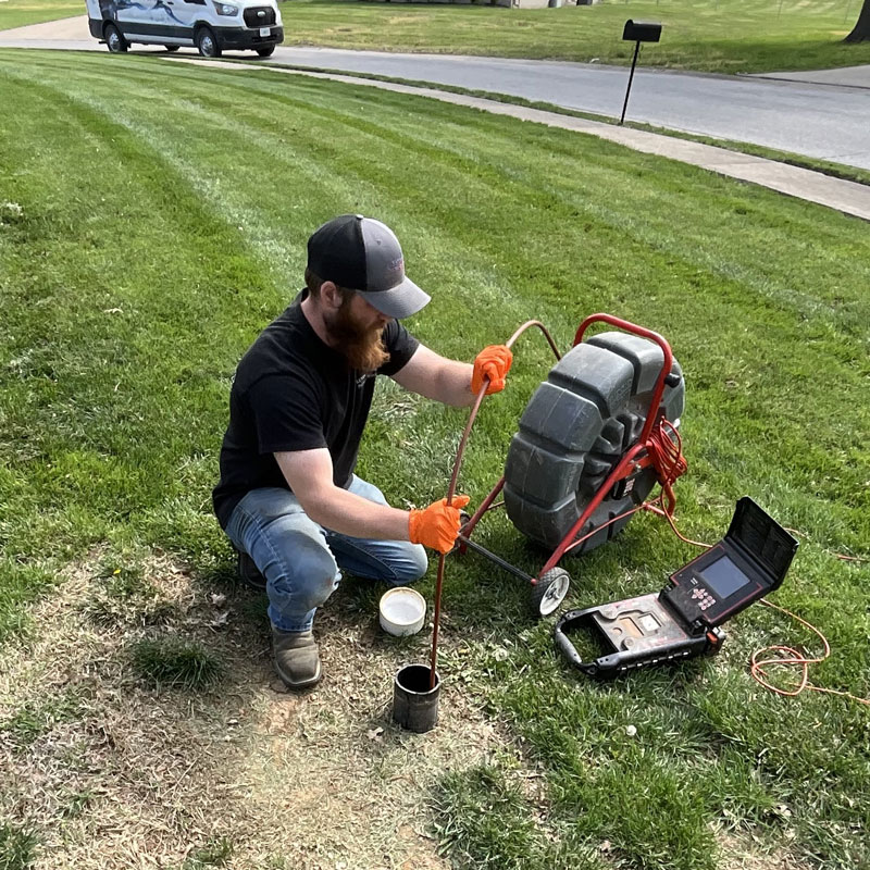 plumber using camera to look at sewer line