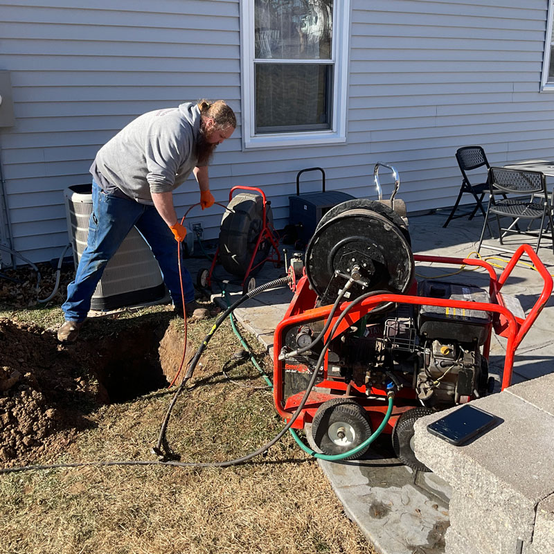 plumber using a jetting machine