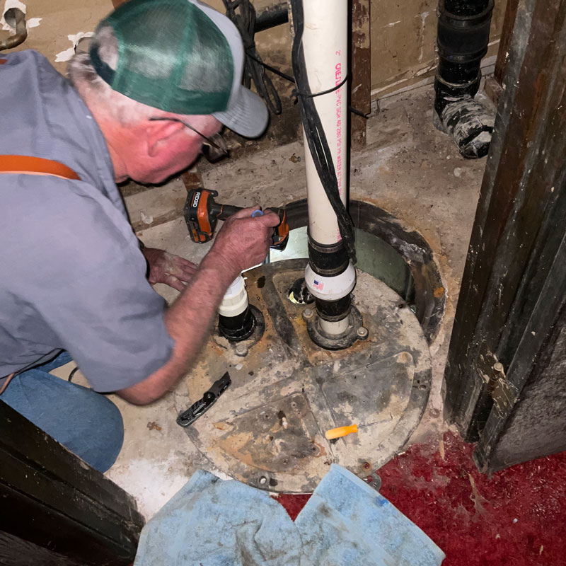 plumber repairing sump pump