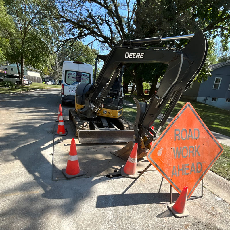 excavator and road work sign