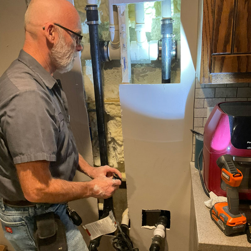 plumber repairing pipes