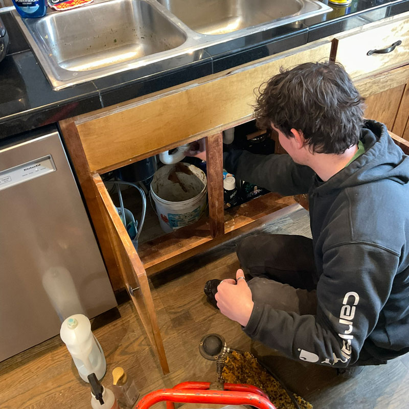 plumber repairing sink